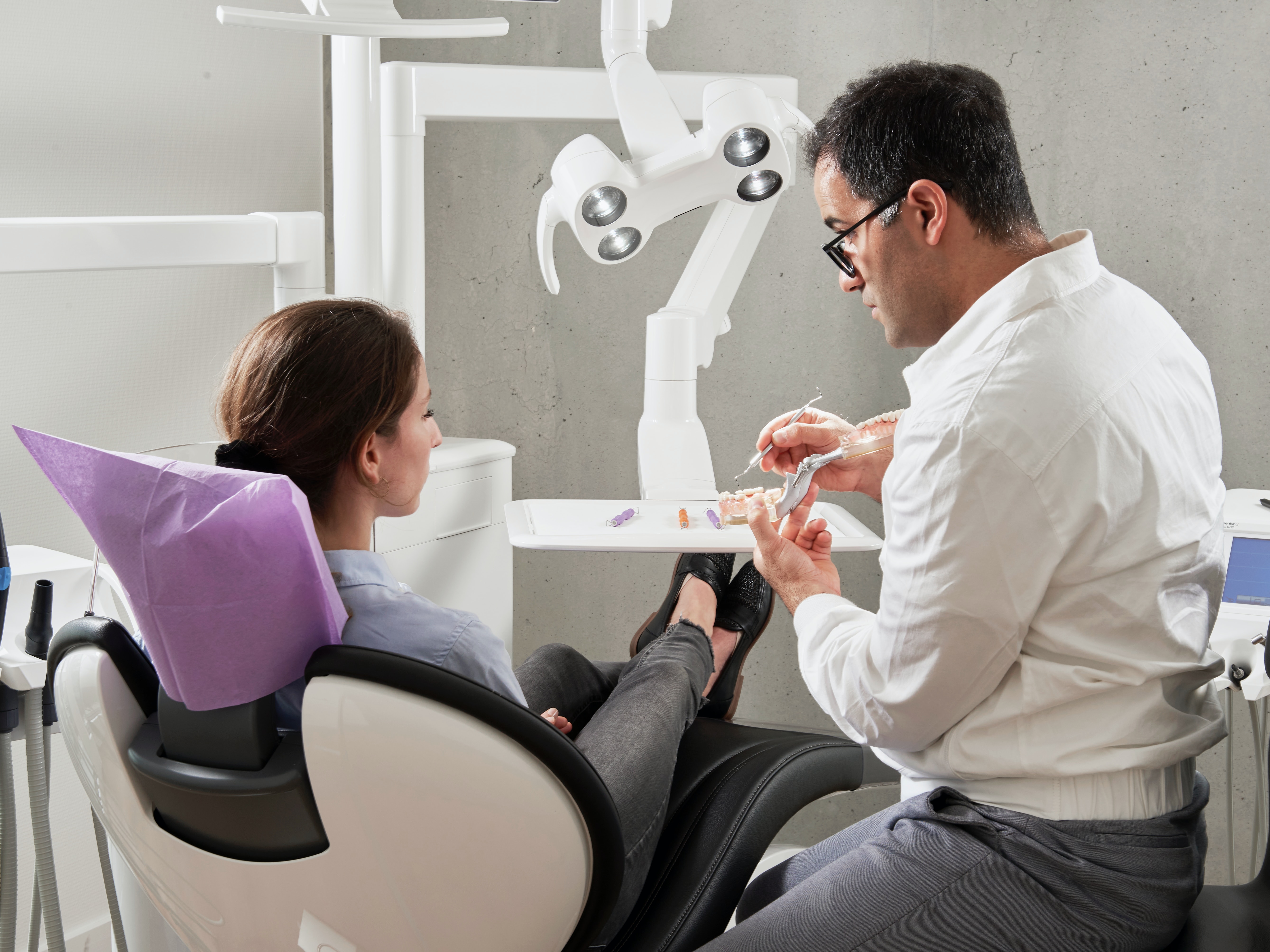 Dentist advising customer on how to better care for her teeth